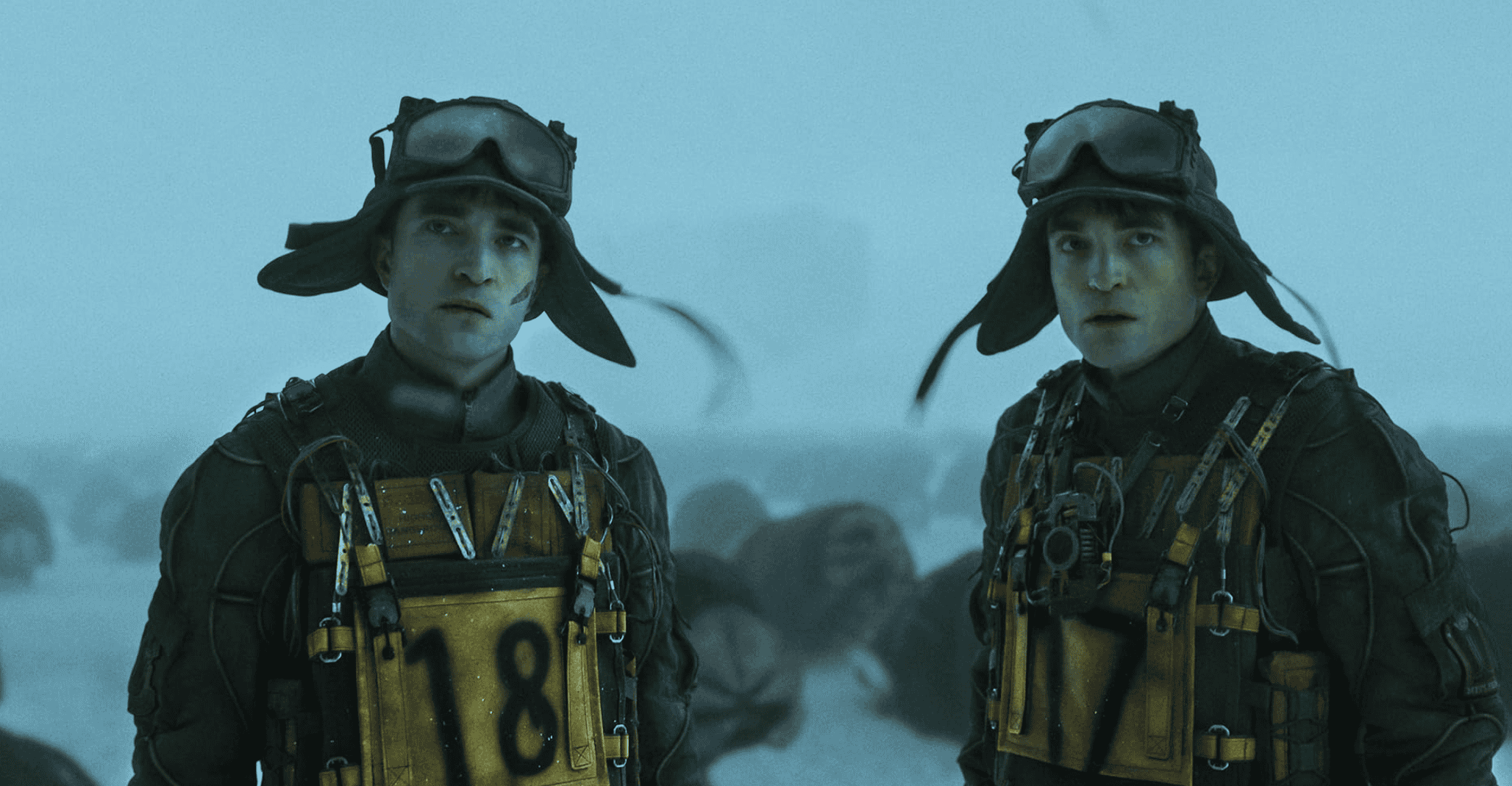 Still from Mickey 17 of Two identical soldiers standing in a frozen landscape, symbolising cloning and duplication in sci-fi cinema.”