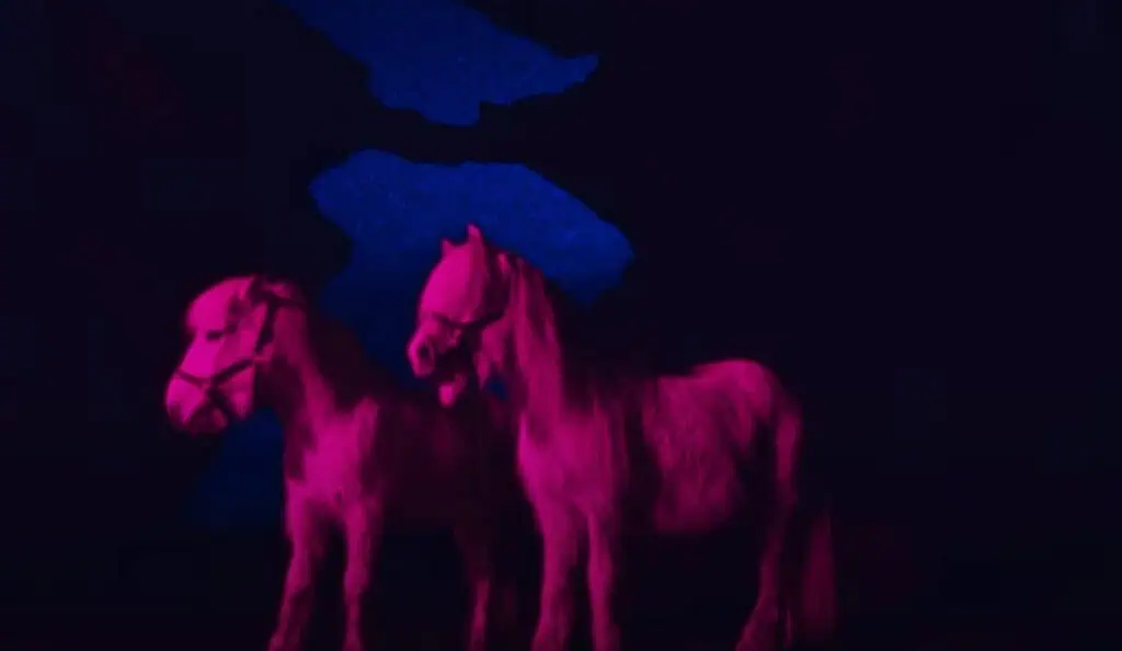 Dreamlike pink ponies in surreal dark blue Icelandic landscape inspired by Elage’s work