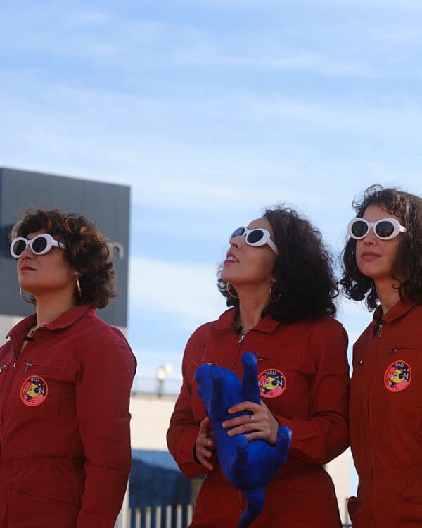 Nelly Ben Hayoun-Stépanian and her doppelgängers in red jumpsuits preparing for space launch