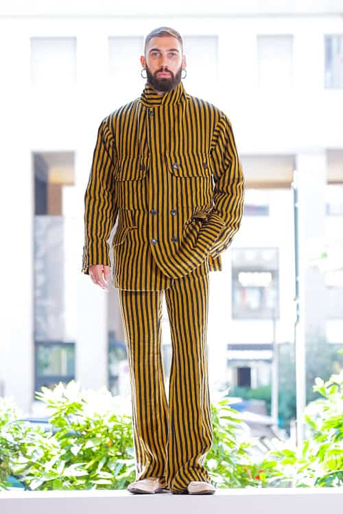 Model in yellow and black striped suit with high collar jacket from Vivienne Westwood Men’s Spring/Summer collection in Milan.