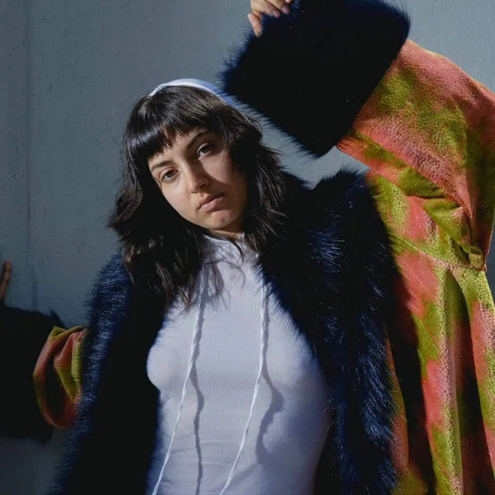 Model in a blue faux-fur coat and white top, from the ECP creative hub editorial