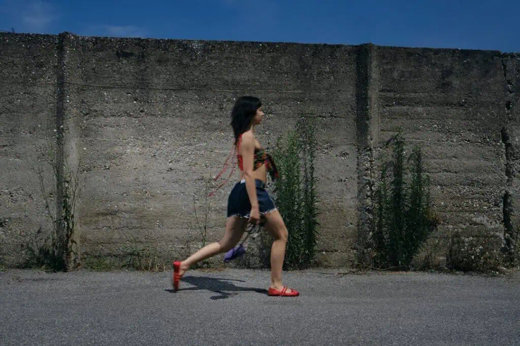 Model running past a concrete wall, from the ECP creative hub editorial
