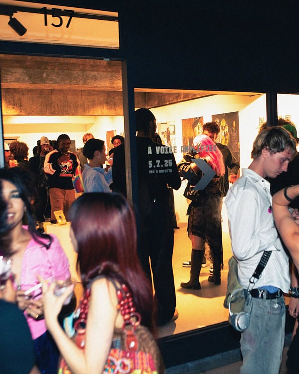 Crowd gathering outside and inside a London gallery during A Voice Amplified, an event showcasing music and youth creativity