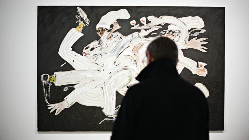 Visitor looking at Jack Penny’s chaotic multi-figure chef painting in the ‘Kitchen of Earthly Delights’ show.