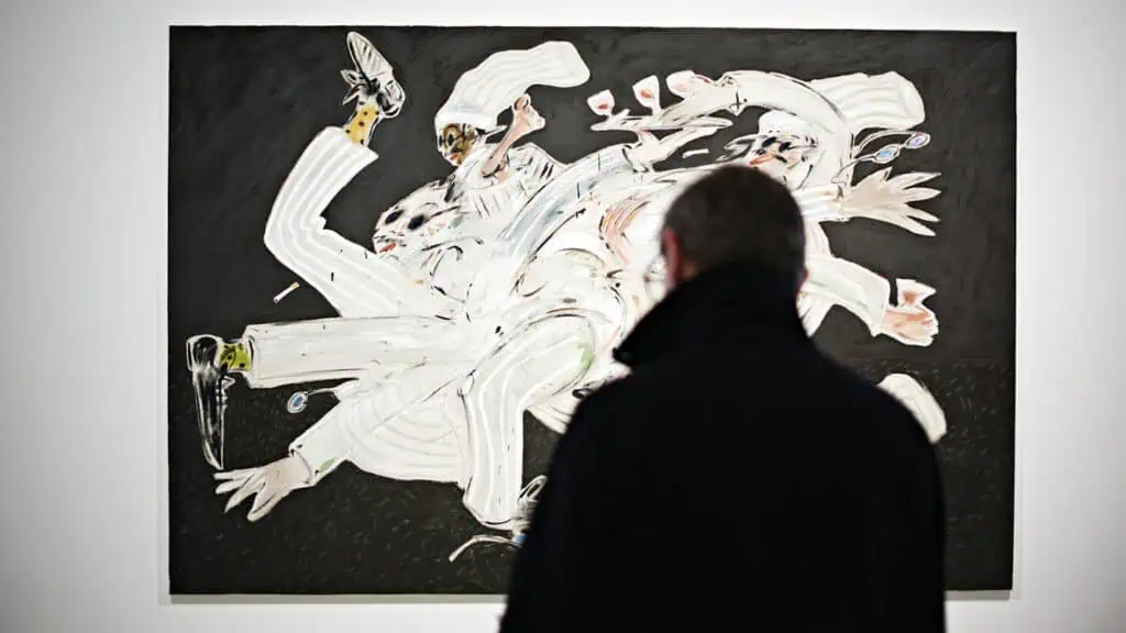 Visitor looking at Jack Penny’s chaotic multi-figure chef painting in the ‘Kitchen of Earthly Delights’ show.