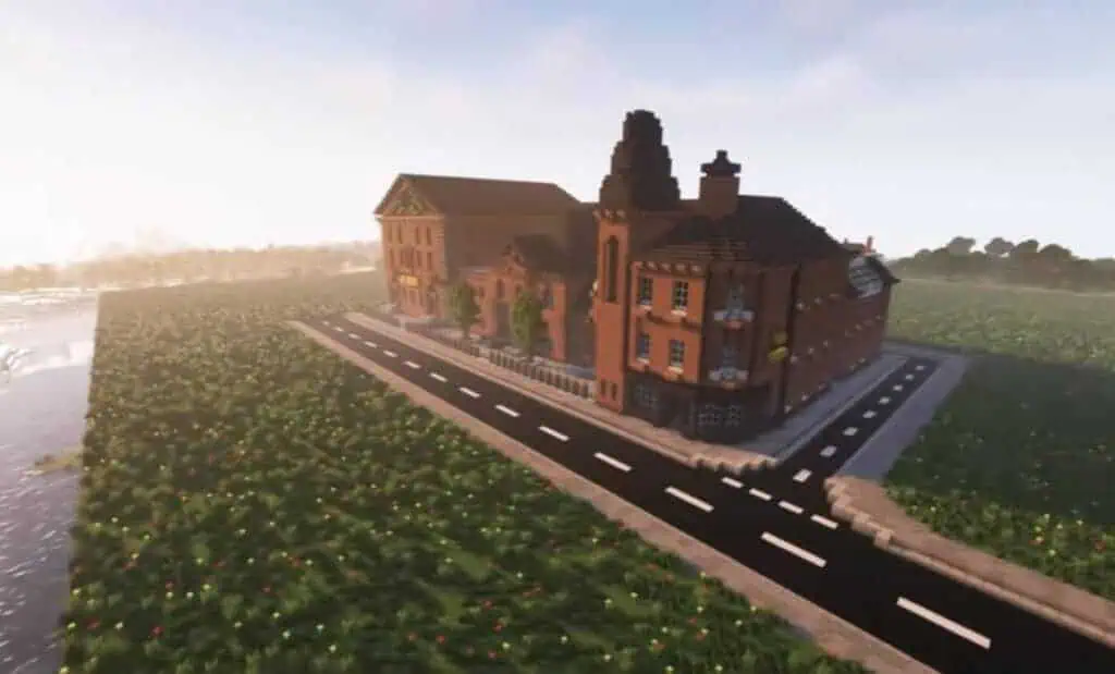 Pixelated Minecraft-style buildings alongside a paved road and flower fields, with a hazy sky in the background