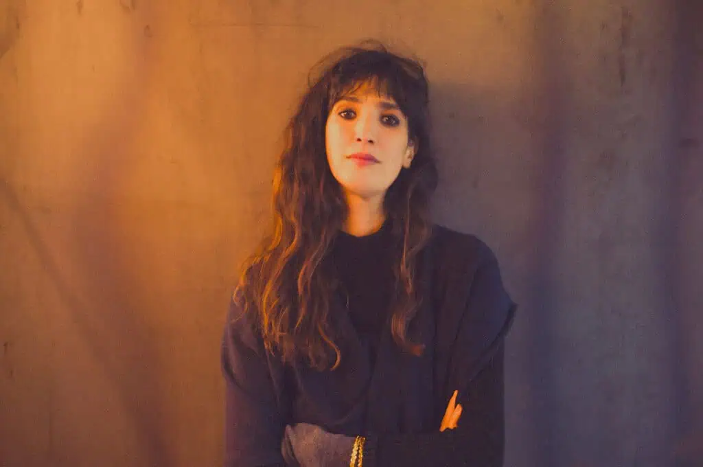 Portrait of playwright and director Caroline Guiela Nguyen, creator of the theatre production LACRIMA exploring the unseen labour behind luxury fashion.