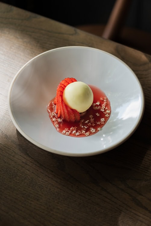 Elegant strawberry and vanilla dessert with floral garnish, plated at The Silver Birch.