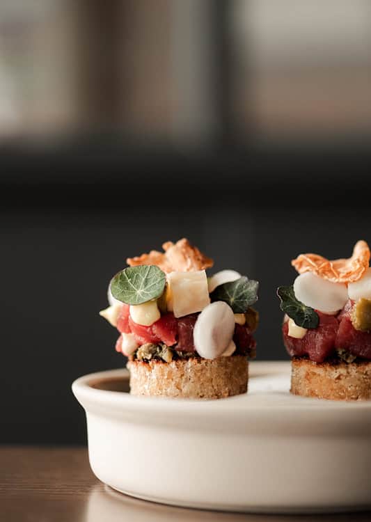 Gourmet tartare canapés topped with fresh herbs at The Silver Birch.