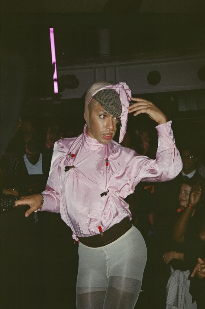 Performer in pink avant-garde outfit at H&M London Fashion Week show.