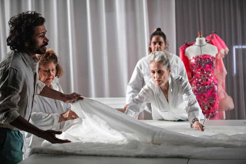 Ensemble cast manipulating layers of white fabric during a workshop scene in LACRIMA, photograph by Jean-Louis Fernandez for Cold Magazine’s article The Weight of Beauty: LACRIMA at The Barbican.