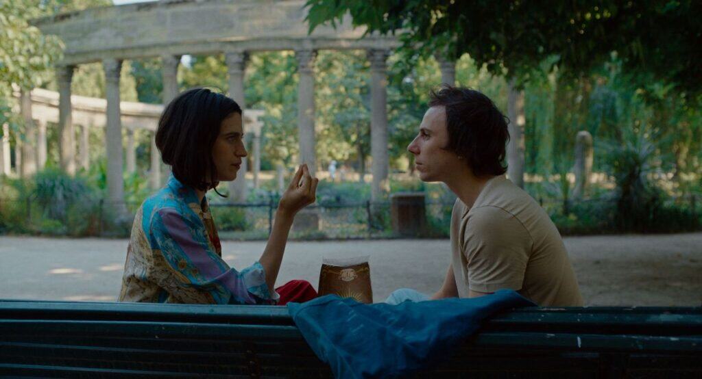 Paulette and Paul sitting on a bench in a park during a scene from “Paul and Paulette Take a Bath.”