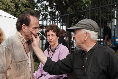 David Lynch directing a scene on set, with producer Sabrina Sutherland observing the process.