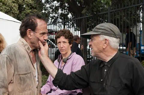David Lynch directing a scene on set, with producer Sabrina Sutherland observing the process.