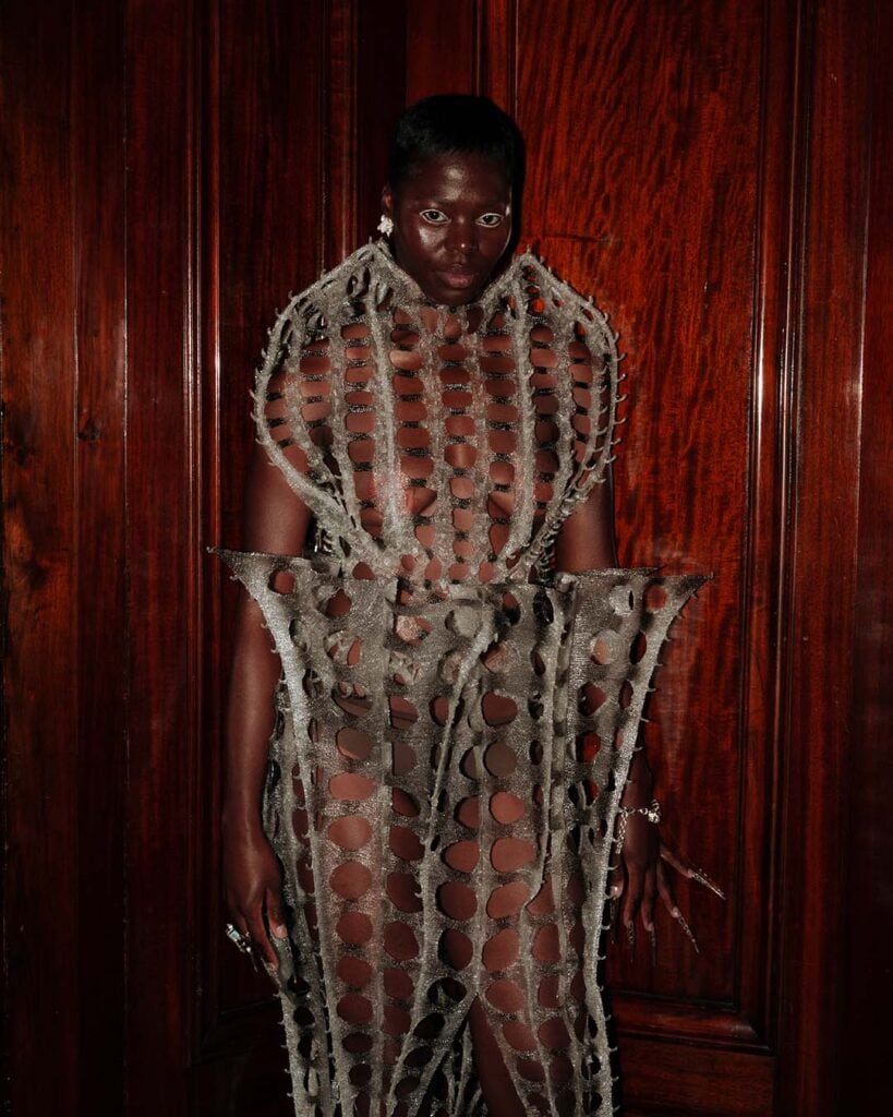 Sculptural cocoon dress from Karina Bond SS26 featuring translucent layered textures inspired by organic forms.