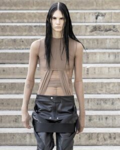 Rick Owens SS26 nude mesh top with exposed corset seams paired with black vinyl skirt.
