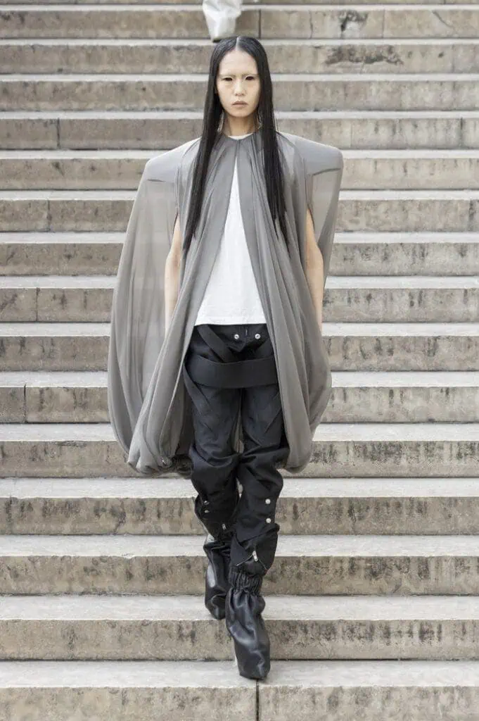 Rick Owens SS26 sheer grey cape layered over white tank and glossy black trousers.