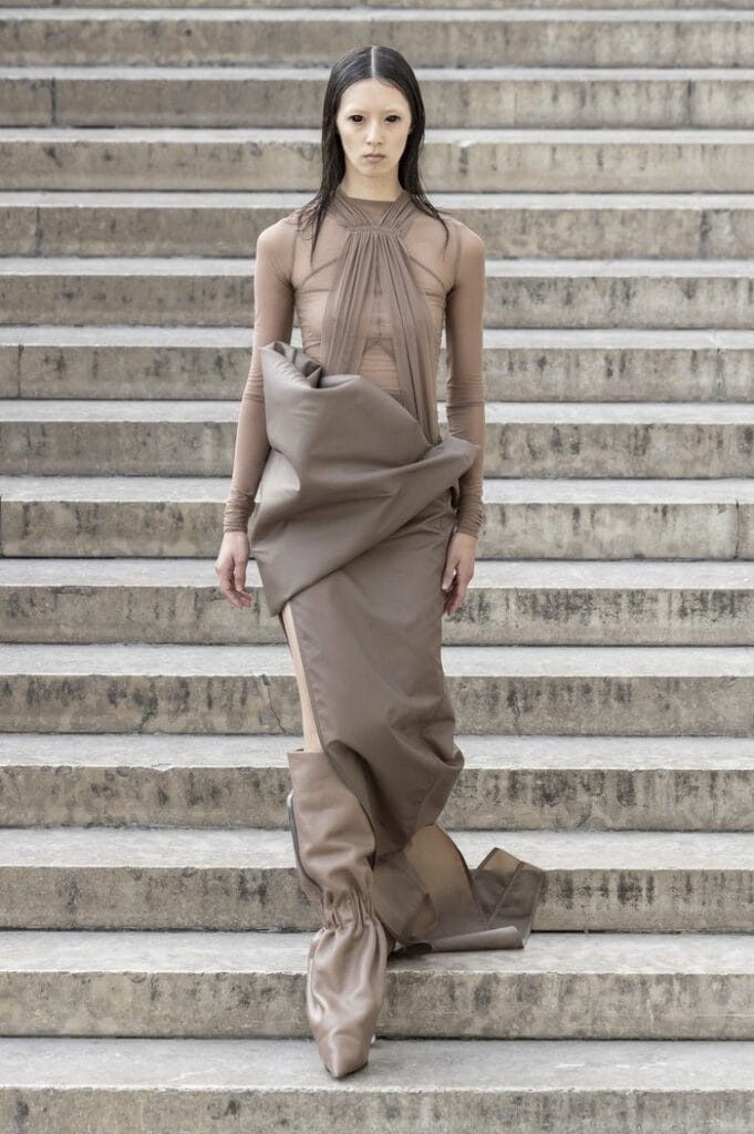 Rick Owens SS26 sculptural nude-toned wrapped dress with gathered fabric volume.