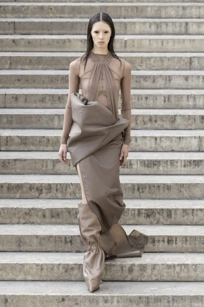 Rick Owens SS26 sculptural nude-toned wrapped dress with gathered fabric volume.