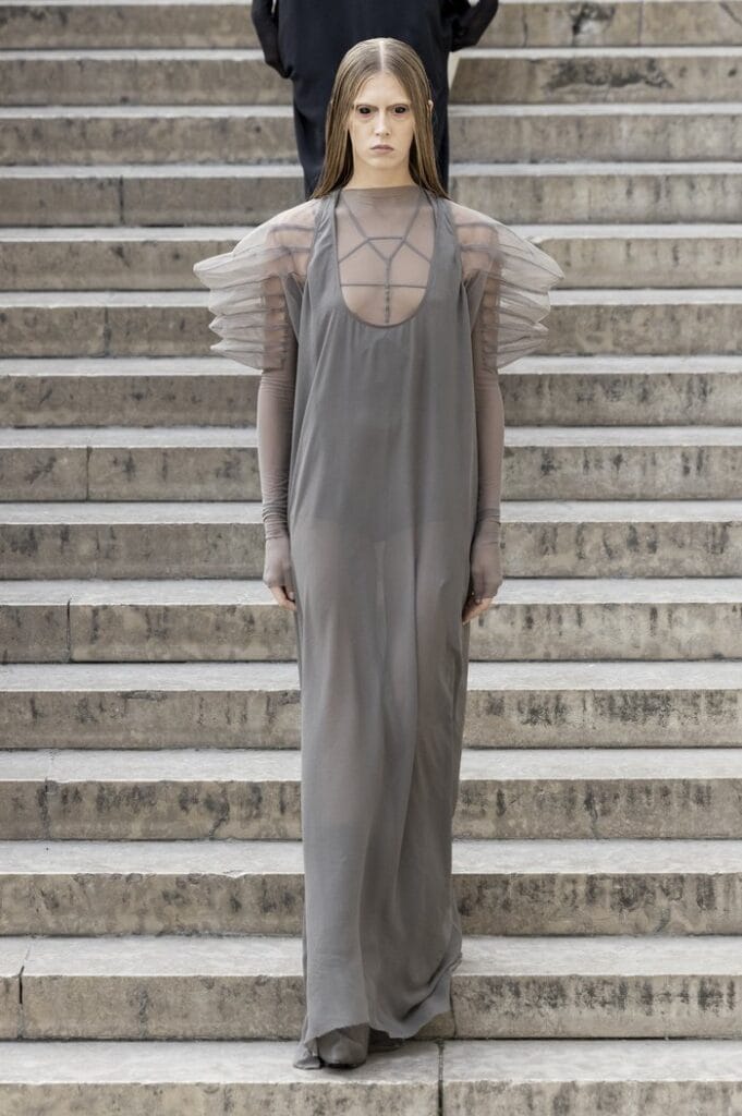 Rick Owens SS26 sheer grey gown with delicate shoulder ruffles and elongated drape.