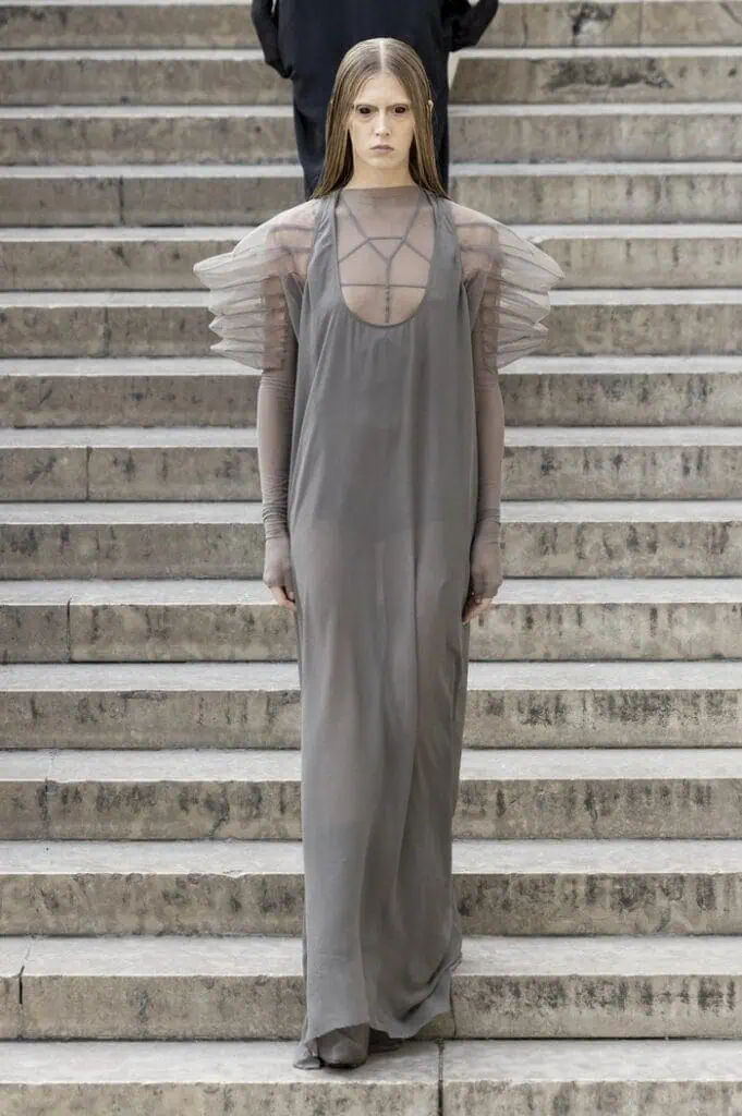 Rick Owens SS26 sheer grey gown with delicate shoulder ruffles and elongated drape.