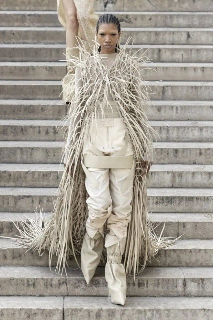Rick Owens SS26 cream look featuring layered fringe textures and sculptural stacked boots.