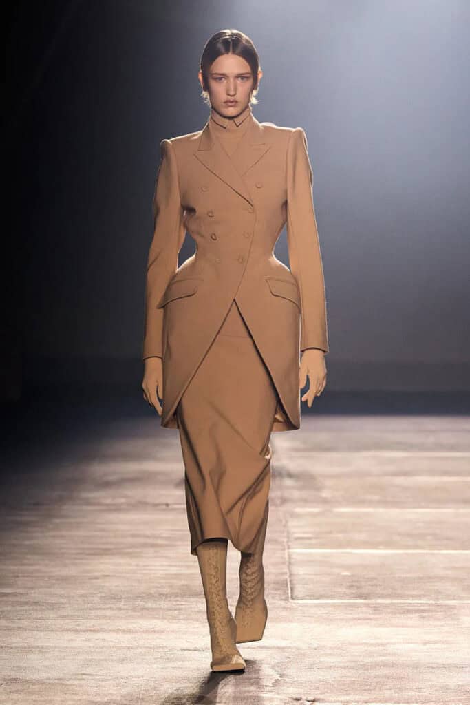 Mugler SS26 structured beige tailored coat dress with layered, angular panel construction.