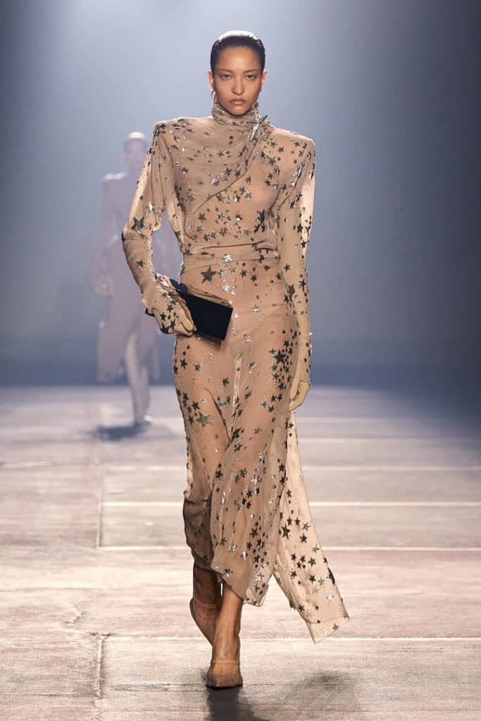 Mugler SS26 sheer nude gown embellished with reflective metallic appliqué details.