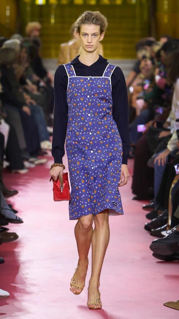 Miu Miu SS26 blue printed slip dress layered over long-sleeve top.