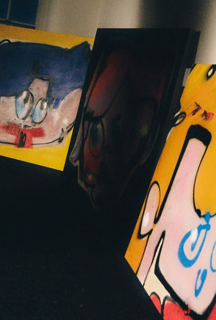 Close-up of Tomas Gittins’ vibrant character paintings featuring bold lines and saturated colours.