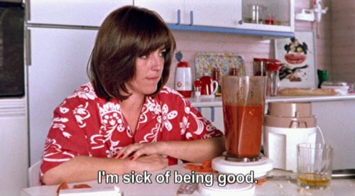 Woman sitting in a kitchen looking frustrated in front of a blender with gazpacho, scene from “Women on the Verge of a Nervous Breakdown” (1988).