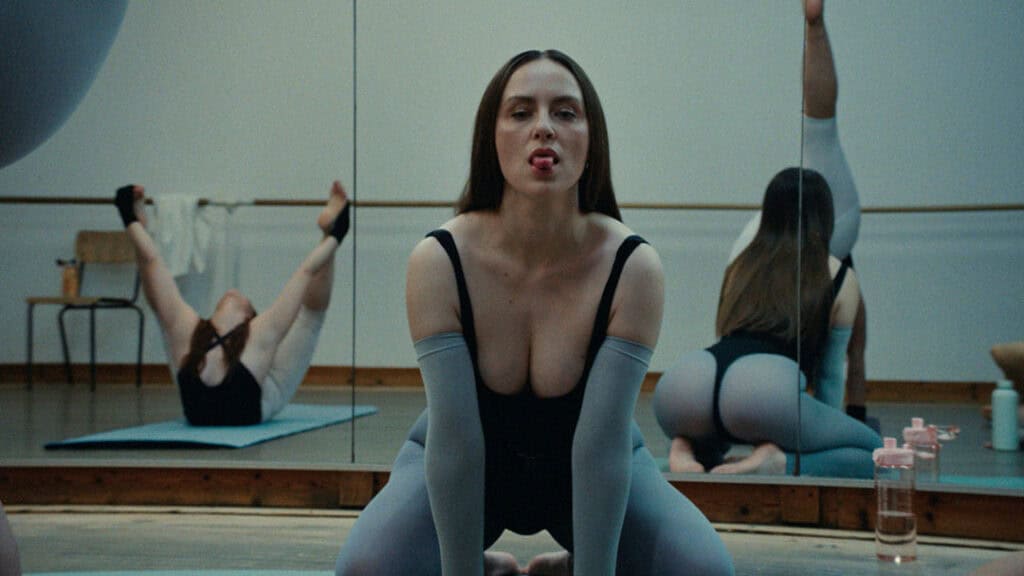 Provocative yoga-inspired pose in a dance studio from Bonnie Banane’s music video ‘Hoes of Na’.