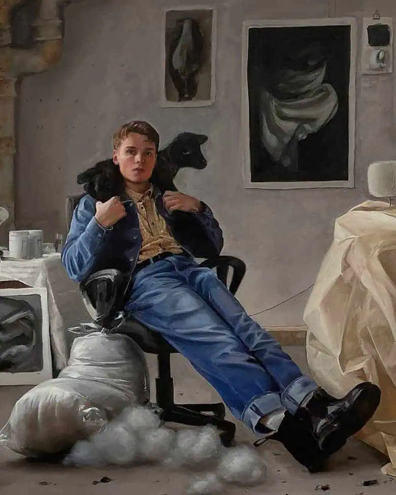 Close-up view of Conor Quinn’s painting Spring, showing a young man seated in a studio chair with a dark lamb draped over his shoulders, surrounded by fabrics and artworks in a softly lit artist’s studio.