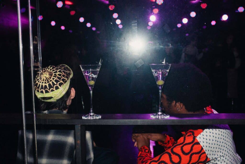 Guests enjoy martinis under neon lights at Sadie Coles’s afterparty at The London EDITION during Frieze Week 2025.