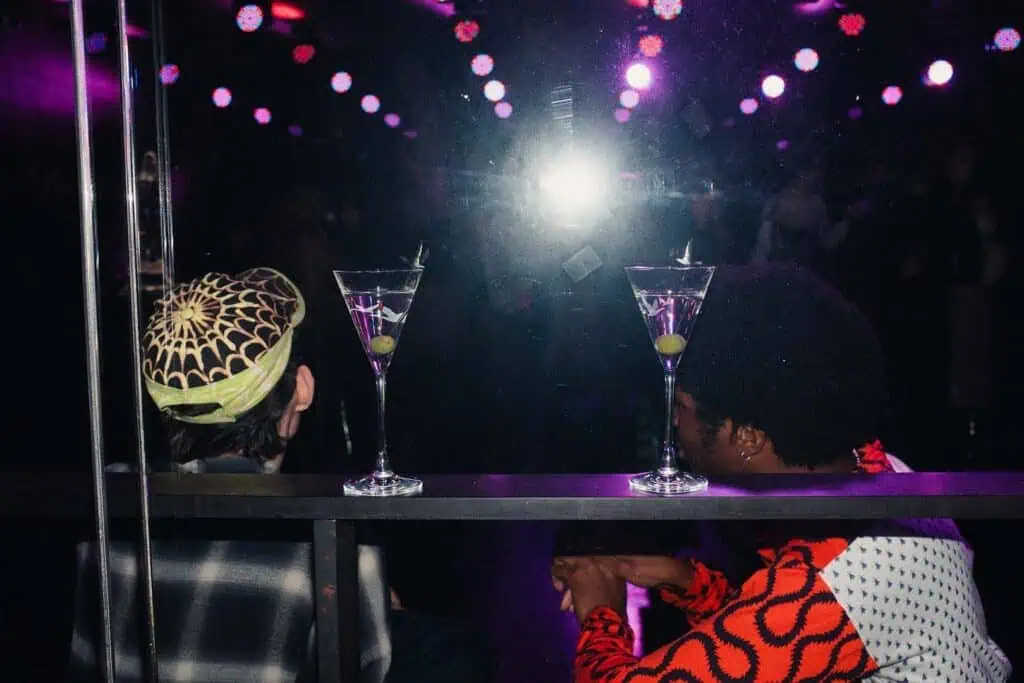 Guests enjoy martinis under neon lights at Sadie Coles’s afterparty at The London EDITION during Frieze Week 2025.
