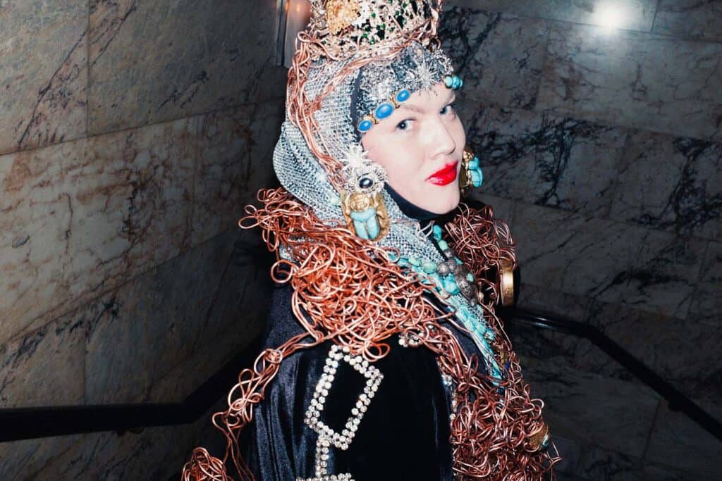 Guest wearing an ornate metallic headpiece and jeweled outfit at Sadie Coles’s closing party for Frieze Week 2025 at The London EDITION.