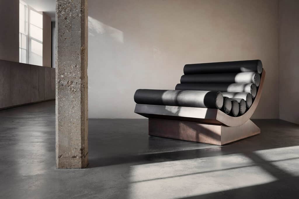 Sculptural chair by Rick Owens and Michele Lamy from Rust Never Sleeps at Carpenters Workshop Gallery, blending brutalist architecture with dark, luxurious design.
