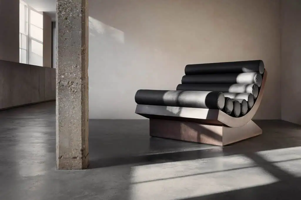 Sculptural chair by Rick Owens and Michele Lamy from Rust Never Sleeps at Carpenters Workshop Gallery, blending brutalist architecture with dark, luxurious design.