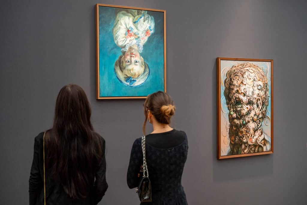 Visitors view Glenn Brown’s surreal portraits at the Gagosian Gallery booth during Frieze Masters 2025, where the artist’s dreamlike brushwork merges realism and abstraction.