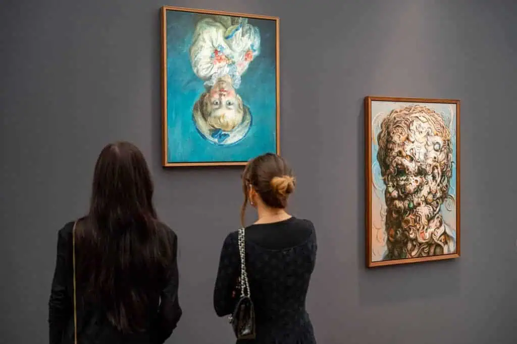 Visitors view Glenn Brown’s surreal portraits at the Gagosian Gallery booth during Frieze Masters 2025, where the artist’s dreamlike brushwork merges realism and abstraction.