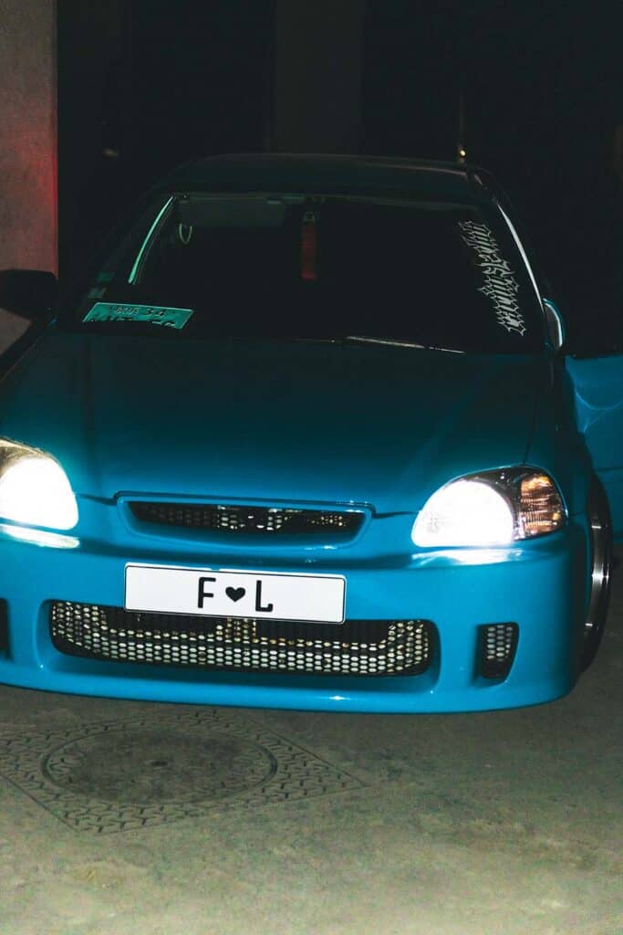 Close-up of a customized blue Honda car with “F ♥ L” license plate at Florentina Leitner SS26 Paris Fashion Week runway.