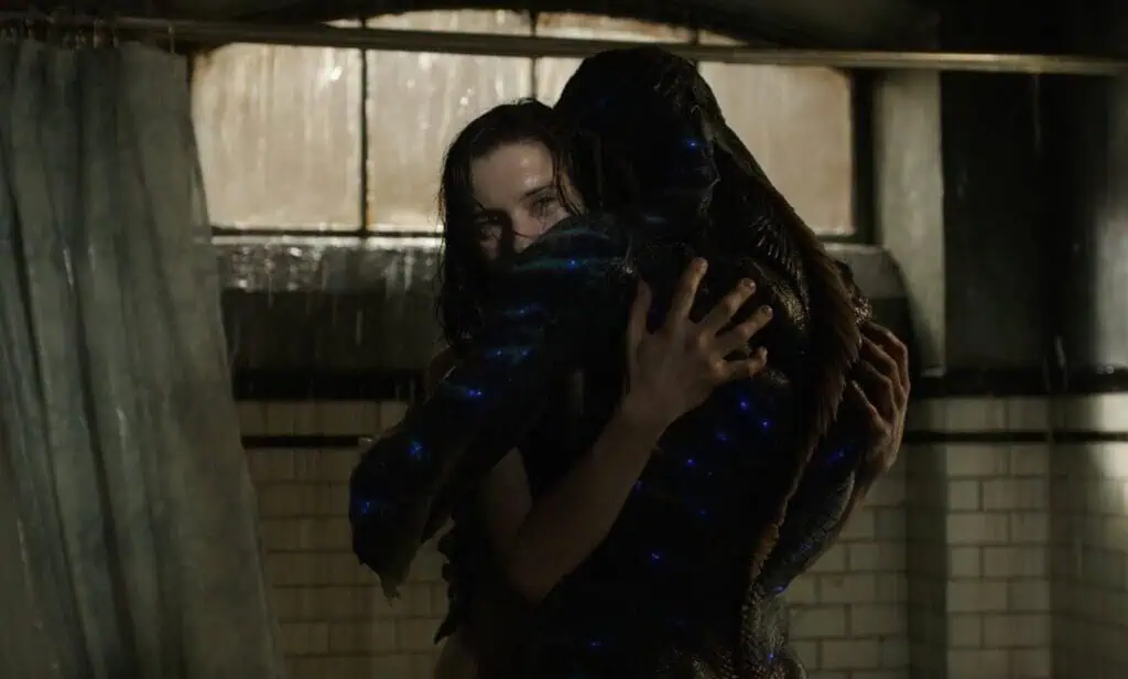 Scene from The Shape of Water showing a woman embracing an amphibious creature under falling water, highlighting Guillermo del Toro’s gothic romance themes.