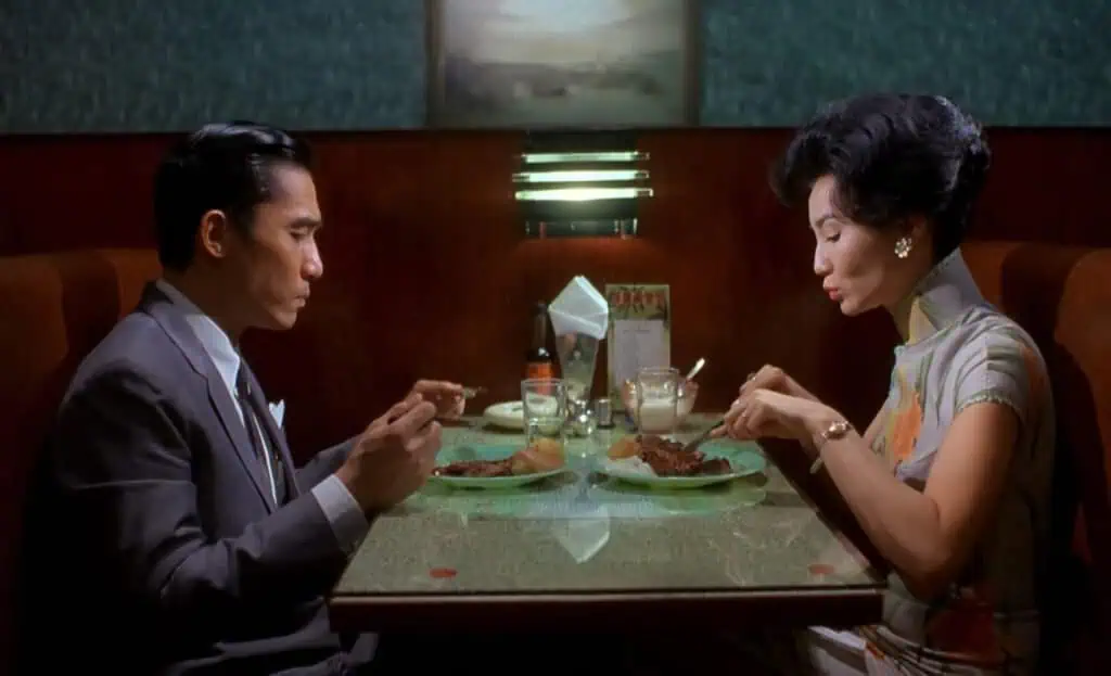 The two main characters sharing a tense and intimate dinner scene in “In the Mood for Love.”