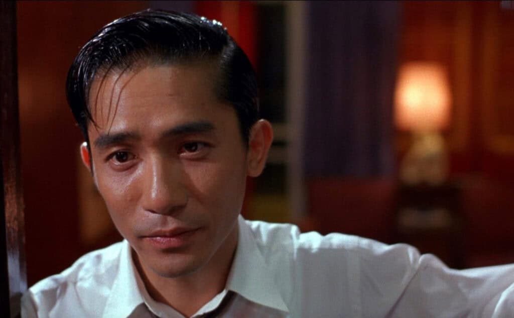 Tony Leung’s character in a close-up scene from “In the Mood for Love,” expressing restrained emotion.
