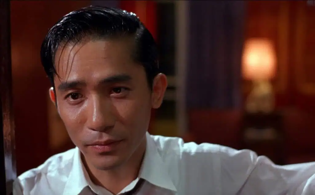 Tony Leung’s character in a close-up scene from “In the Mood for Love,” expressing restrained emotion.