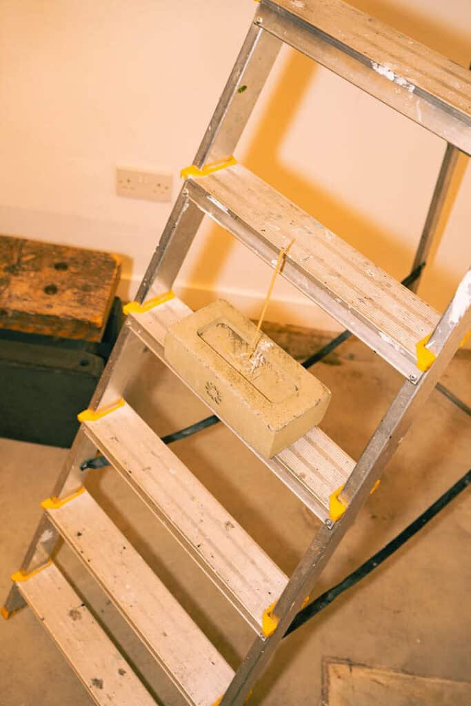 Detail of the raw, work-in-progress setup inside Gander’s AW25 showcase, featuring a ladder and concrete block.