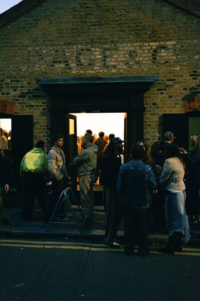 Guests gathering outside Gander’s AW25 presentation at 228 Brick Lane, London, before entering the exhibition space.