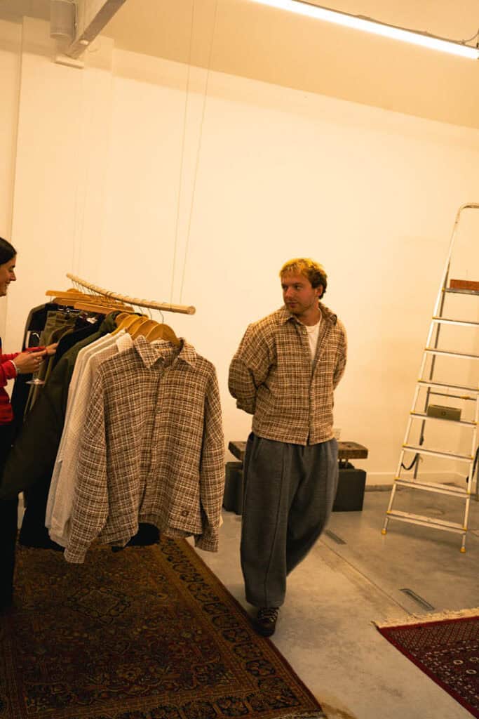 Gander founder Calum Gregory inside the AW25 presentation space, surrounded by pieces from the new collection.