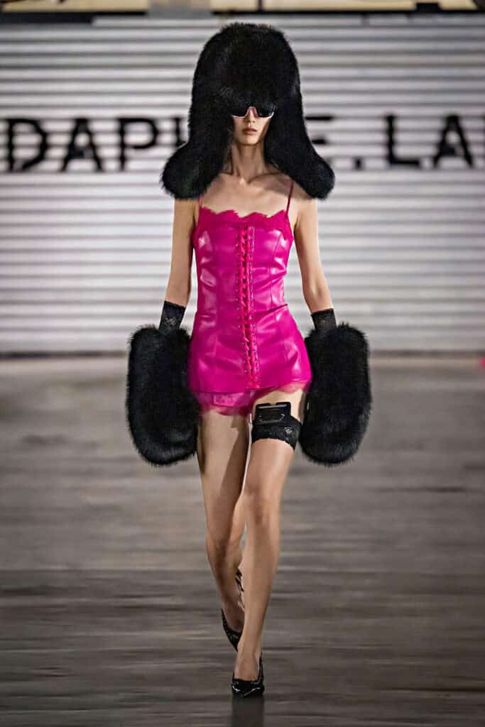Model in hot pink lace-up dress with oversized furry accessories from the Daphne.lab × Marrknull Shanghai Fashion Week show.