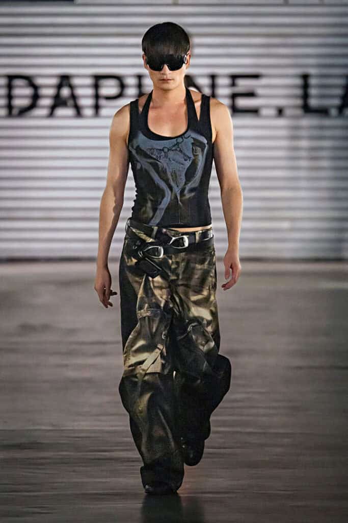 Male model wearing fitted printed top and cargo trousers in the Daphne.lab × Marrknull “In a Hurry” collection.